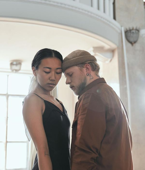 Woman performing a gentle cardio movement in a calm, modern studio.